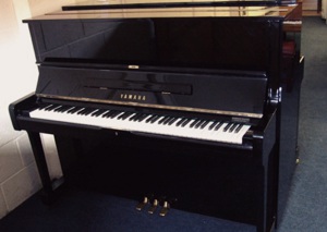 black upright piano by yamaha pianos